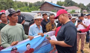 Bupati Edi Damansyah saat menyerahkan bantuan kepada kelompok tani.